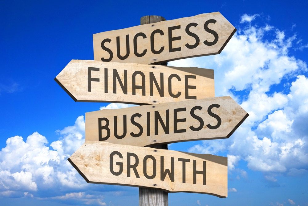 Wooden,Signpost,With,Four,Arrows,-,Success,,Finance,,Business,,Growth.